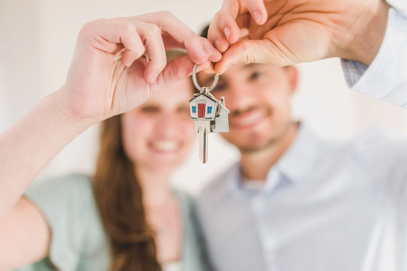 A couple holding up the keys to their new home